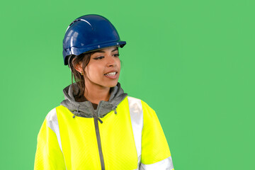Construction worker in reflective gear on a green background discussing safety protocols while...
