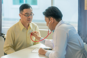 Doctor sitting on chair checking heart rate of asian senior man medical concept doctor examining...