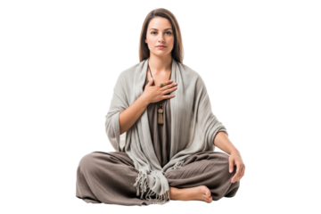 Peaceful woman in comfortable clothing sitting cross-legged with hand over heart in a meditative or spiritual pose
