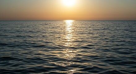 Obraz premium Sunset Over Calm Ocean Water Scene with Golden Reflection