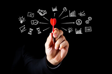 Hand holding red dart with business concept icons image