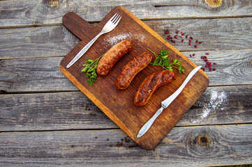 juicy bbq sausages served on a wooden board