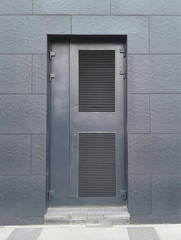 Door in  power transformer electric substation in building wall.
