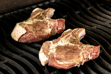 Cooking steak on a gas grill with vegetables.