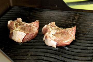 Cooking steak on a gas grill with vegetables.