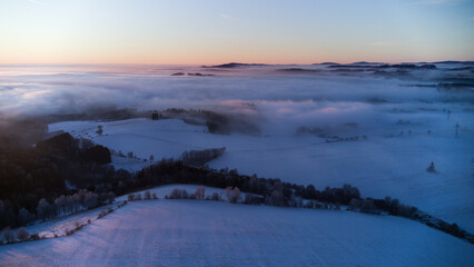 View of the snowy landscape of the Krkonoše Mountains during an inversion