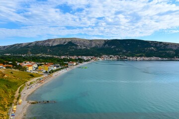 Beach in the town of Baška bellow the mountains at the coast of the Adriatic sea in Kvarner, Croatia