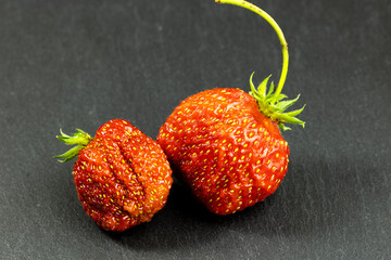 Juicy red strawberry berry. Carved on a black background