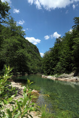 a river at the bottom of a canyon, among the mountains