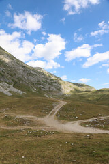 landscape of mountain range with tourist paths Montenegro, Durmitor National Park against the background of sky with clouds