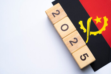 2025, Angola flag with date block, Concept, Important events for Angola the new year, election,...