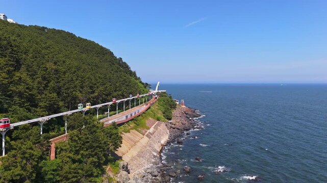 Aerial view following the Haeundae Sky Capsules at Blueline Park, in Busan, Korea