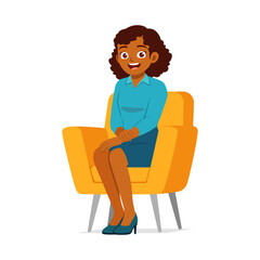 Cheerful African American woman smiling sitting on chair in blue dress