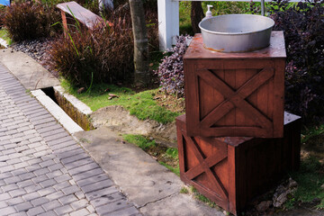 A Hand washing facilities with a stand made from stacked treasure chests. DIY craft creativity. A...