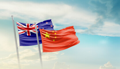 New Zealand and China flags waving in beautiful sky. Two country flag for agreement or deal. New...