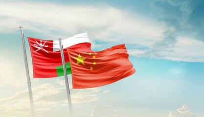Oman and China flags waving in beautiful sky. Two country flag for agreement or deal. Oman China national flag for commitment.