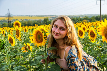 blonde woman in field of yellow sunflowers, portrait, looking into lens, smiling, teenager, bright...