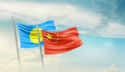 Palau and China flags waving in beautiful sky. Two country flag for agreement or deal. Palau China...