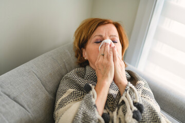 women with stress that suffer from allergies and close the nose with tissue paper. Because of...