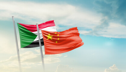 Sudan and China flags waving in beautiful sky. Two country flag for agreement or deal. Sudan China...