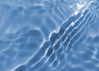 Abstract blurred shades of blue water background. Light and shadow ripples or splashes surface of water texture. Water waves with shining and reflection pattern photography for​ design artwork.