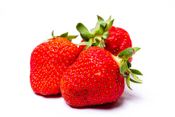 three fresh strawberries on a white background