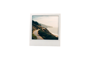 Vintage polaroid photo showing coastal highway winding through hills and mountains, isolated on a transparent background