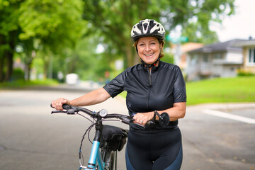 Happy mature cyclist woman enjoying healthy activity