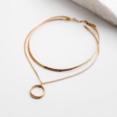 A gold bracelet with a circle pendant on it