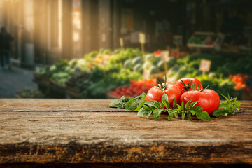 Fresh vegetables on rustic wooden table with empty space for product display or text, background of blurred farmers market stall with colorful organic produce, healthy food and eco lifestyle concept.