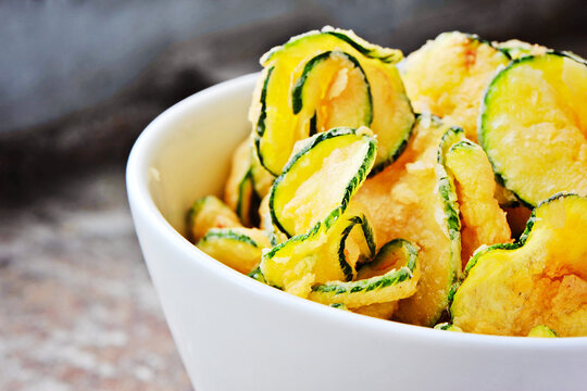 deep fried zucchini chips in white bowl
