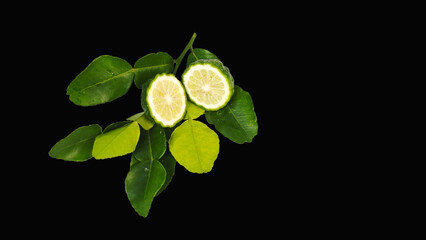 Kaffir lime and leaves on black background.
