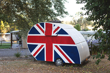 Old-fashioned caravan adorned with the Union Jack, symbolizing British pride