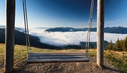 Fototapeta premium wooden swing overlooking mountain valley above the clouds