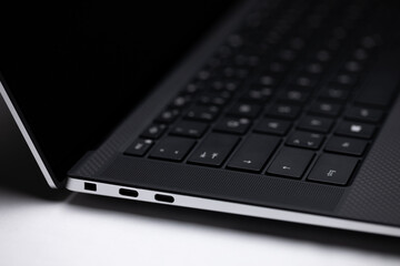 Side view of open laptop with focus on USB-C ports
