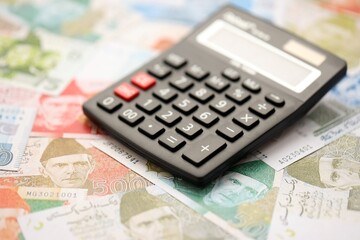 Pakistan rupees banknotes and calculator. The current Pakistan money bills with calculator