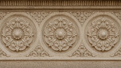 Exterior architectural decorations consisting of plaster stucco, wall textures, molded plaster, and design patterns seen in public urban environments.