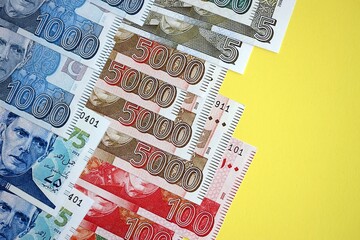 Pakistan rupees banknotes on yellow background. The current Pakistan money bills