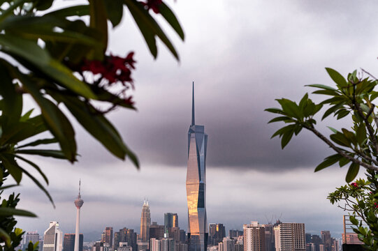Kuala Lumpur skyscrapers framed by lush rooftop plants, Malaysia