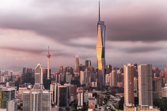 Moody Kuala Lumpur skyline under glowing sunset clouds