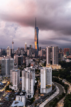Golden light illuminating Kuala Lumpur skyline before twilight