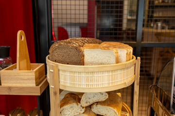 Sliced bread displayed on wooden trays in a buffet setting