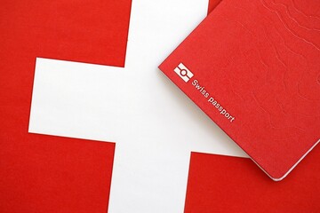 Swiss passport on flag. The current Swiss pass on flag close up