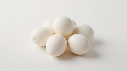 arrangement of white eggs on a clean white surface with soft shadows creating a minimalistic composition