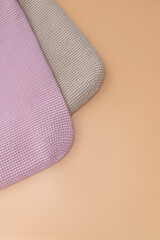 Crocheted cushions in soft pastel colors arranged on a beige surface