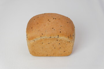 Organic sourdough bread with sunflower seeds, sesame and flax on a white background. Healthy bread recipe