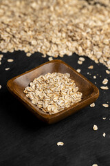 flakes into a bowl, oatmeal for quick cooking of porridge, close up
