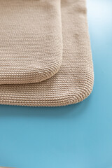 Textured woven mats displayed on a vibrant blue surface in a well-lit setting