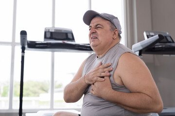 Exercise, Chest pain. Male with chest pain after workout, training. Tired or breathing problem...