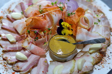 Food tray with delicious salami, sausage. Meat platter with selection. Delicious sliced sausages on plate